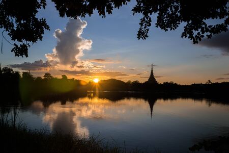 Silhouette thai temple in north east thailand sun set periodの写真素材
