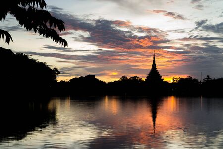 Silhouette thai temple in north east thailand sun set periodの写真素材