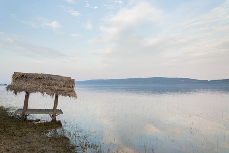 Peaceful hut beside large damの写真素材