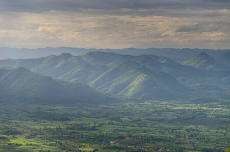 Fantastic layer of mountain and field with light effectの写真素材