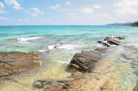 View of beautiful beach with rocky cliffs at Thailandの写真素材