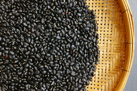 Black beans for background on bambooの写真素材