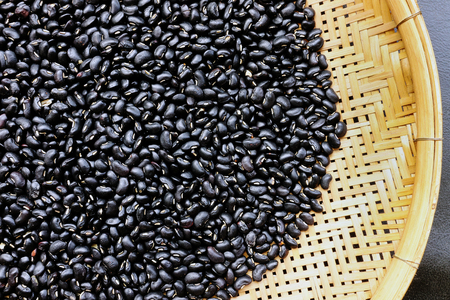 Black beans with bamboo texture background.の写真素材