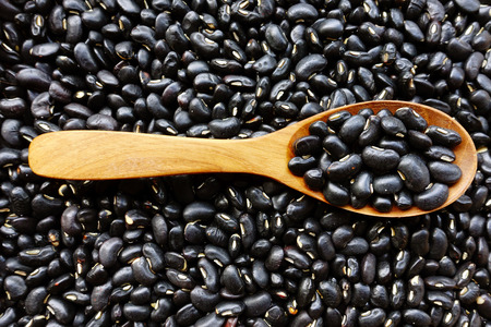 Black beans with a wooden spoonの写真素材
