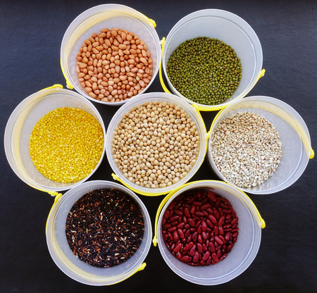 Mixed beans and lentils of different legumes on black backgroundの写真素材