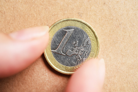 euro coin on hand for backgroundの写真素材