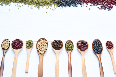 Assortment of beans and lentils in wooden spoonの写真素材