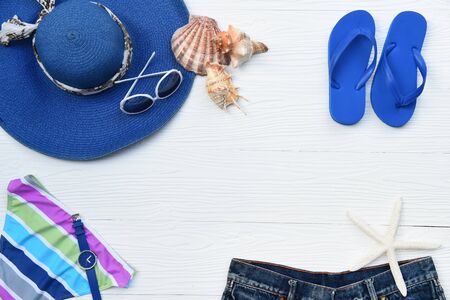 Summer hat and sunglasses with accessories and sandals on white backgroundの写真素材