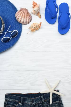 Summer hat and sunglasses with accessories and sandals on white backgroundの写真素材