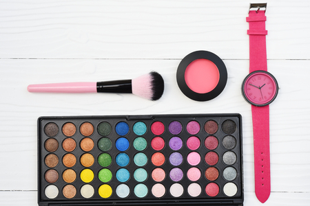 watch and collection of make up and cosmetic beauty products arrangedの写真素材