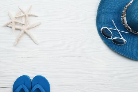 Summer hat and sunglasses with accessories and sandals on white backgroundの写真素材