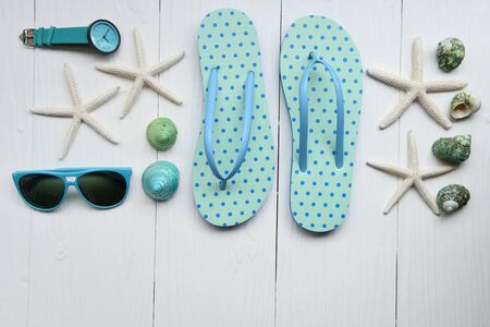 Summer hat and sunglasses with accessories and sandals on white backgroundの写真素材