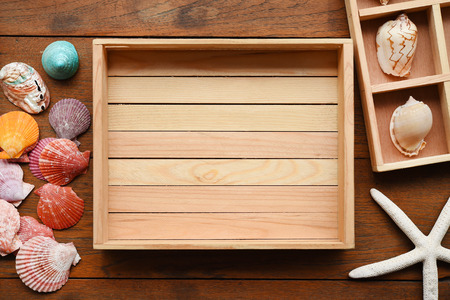 Shells in wooden box for backgroundの写真素材