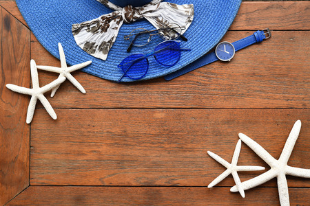 Summer straw hat and starfish on wooden backgroundの写真素材