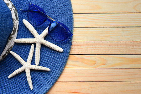 Summer straw hat and starfish on wooden backgroundの写真素材