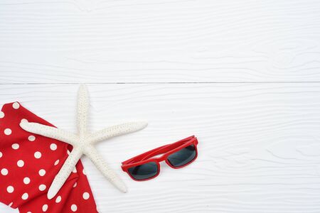 Summer hat and sunglasses with accessories and sandals on white backgroundの写真素材