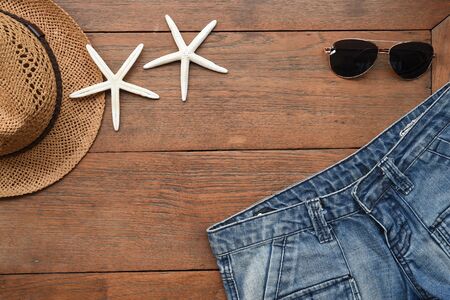 jeans texture and sandals with accessories on wooden background