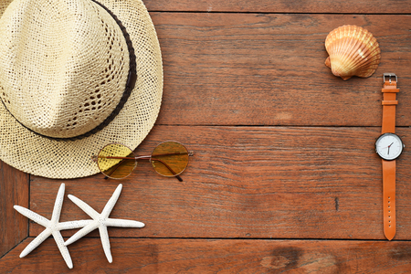 Summer hat and with accessories and sandals on wooden backgroundの写真素材