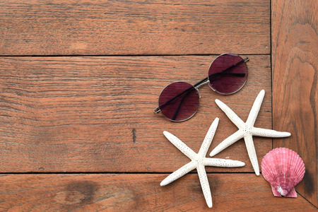 Shells and starfish on wooden backgroundの写真素材