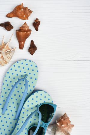 blue sandals and shells isolated on white backgroundの写真素材