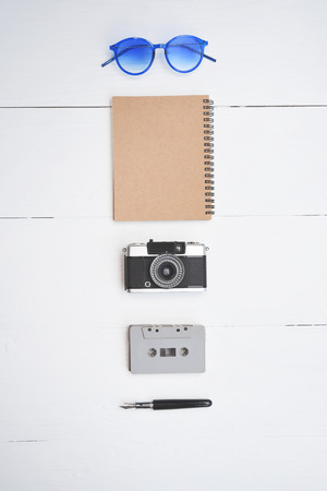Top view of travel accessories with a passport, camera, notebook, glasses isolated on white backgroundの写真素材
