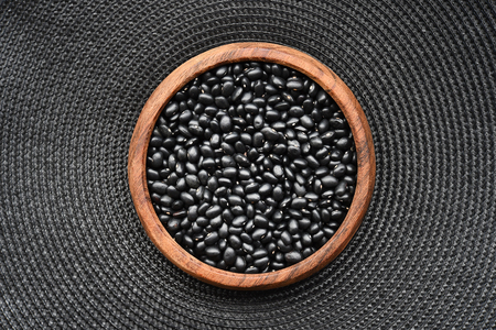 Black beans in wooden bowlの写真素材