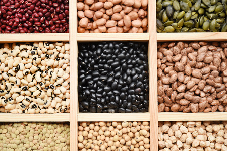 collection of different legumes in wooden bowlの写真素材