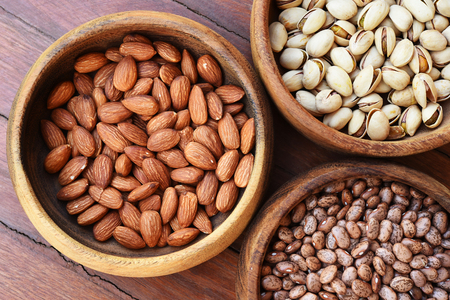 almond and pinto bean with pistachios in wooden bowlの写真素材