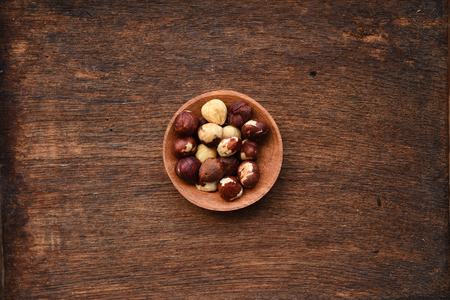 close up of hazelnut in wooden bowlの写真素材