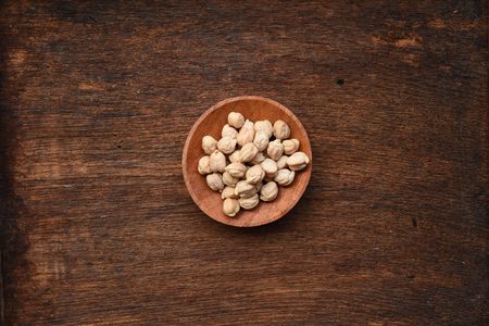 close up of garbanzo beans in wooden bowlの写真素材