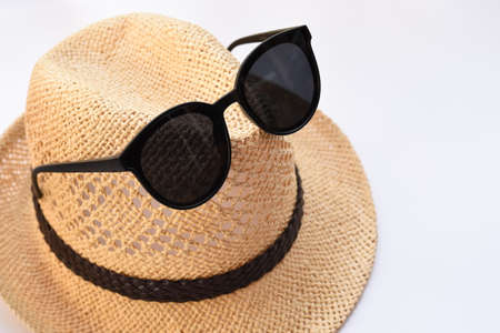 Summer hat and sunglasses isolated on white background