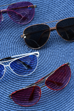 Summer hat and sunglasses on black backgroundの写真素材