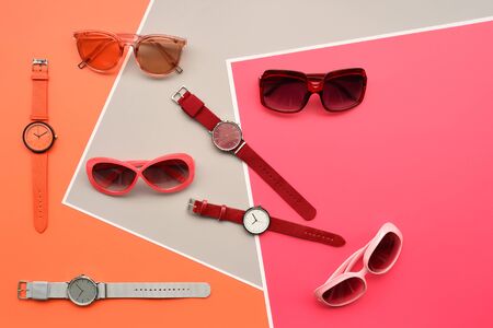 Set of color lipsticks with fashionable sunglasses for background