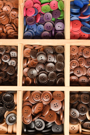 close up of beautiful colored wooden buttons for backgroundの写真素材