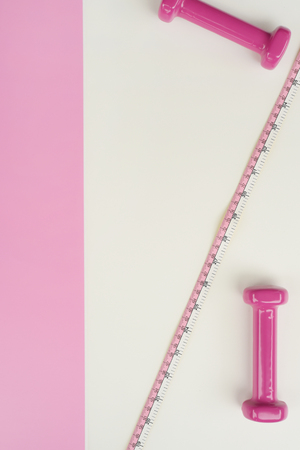 Fitness concept dumbbell and measuring tape for backgroundの写真素材