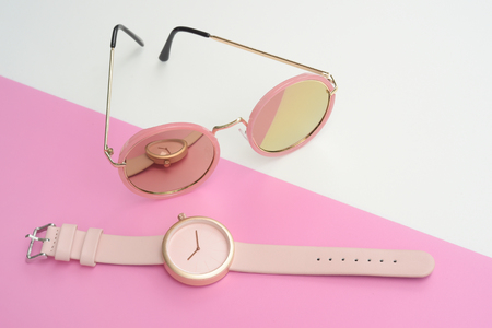 Set of multicolored wristwatches with fashionable sunglasses for backgroundの写真素材
