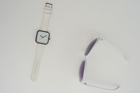 Set of multicolored wristwatches with fashionable sunglasses for backgroundの写真素材