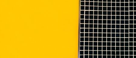 Concrete wall decorated with tile and painted yellow color for background
