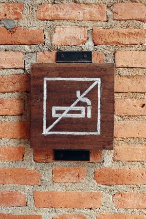 No smoking sign on orange brick wallの写真素材