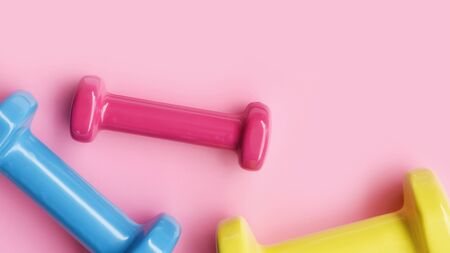 close up of dumbbell on pink background