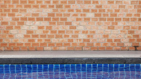 Old red brick wall texture with swimming poolの写真素材