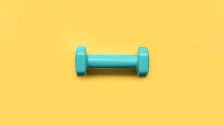 close up of dumbbell on yellow backgroundの写真素材