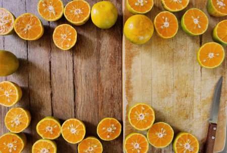 Orange fruit with cut in half on wooden backgroundの写真素材