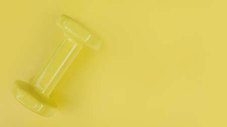close up of dumbbell on yellow backgroundの写真素材