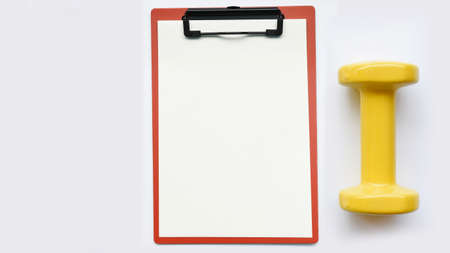 empty paper and dumbbell isolated on white backgroundの写真素材