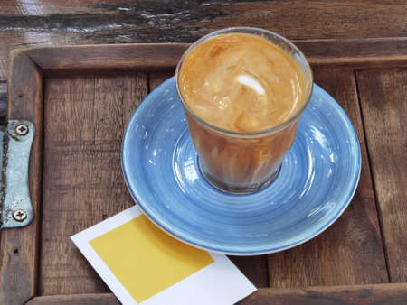 Coffee cup top view on wooden table backgroundの写真素材