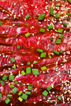 Sliced raw beef with special sauce for cookingの写真素材