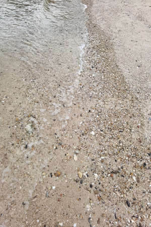 Wave of the sea on the sand beachの写真素材