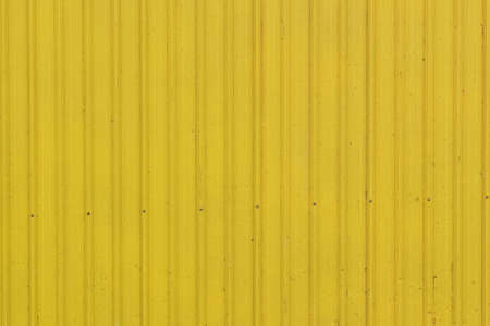 Close up of a yellow metal sheet part of a roofの写真素材