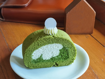 Matcha green tea roll cake on wooden tableの写真素材